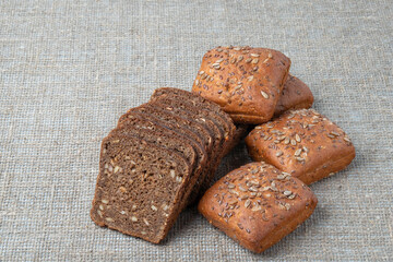 Rye bread with seeds, on the background of burlap