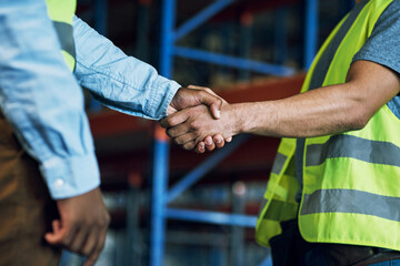 Proud to have a reliable partner like you. Shot of two builders shaking hands at a construction...