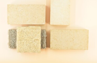 natural raw wood fiber thermal insulation panel samples view from above on a beige surface