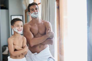 Cool, yo. Cropped shot of a handsome young man teaching his son how to shave in the bathroom.