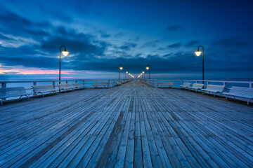Fototapeta premium Beautiful landscape with wooden pier in Gdynia Orlowo at sunrise, Poland