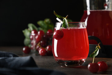 Red cherry freshness homemade compote in glass on dark background. Close up.