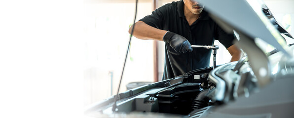 Close-up hand auto mechanic using the wrench to repairing car engine problem. Concepts of check and fix car and maintenance servicing. - obrazy, fototapety, plakaty