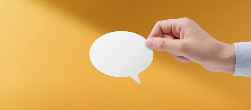 Woman holding a white speech bubble