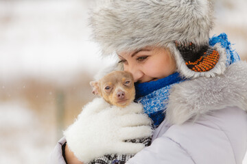 Obraz premium Woman playing with dog during winter