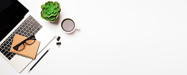 Top view desk flat lay background in vintage retro style with computer laptop and office equipment for empty work area copy space concept.