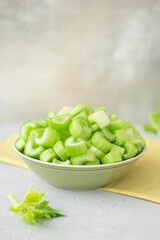 chopped stalks of fresh celery in a green plate