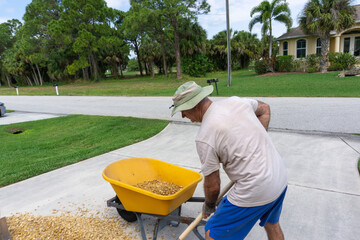 Man scoops rocks for Florida landscaping