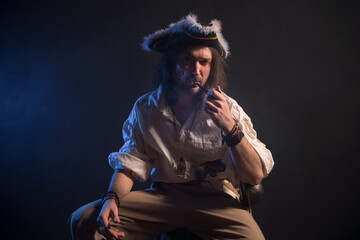 Fototapeta premium Pirate filibuster sea robber in suit with gun and saber. Concept photo