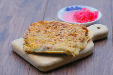 Malaysia muslim food Martabak or murtabak on wooden cutting board