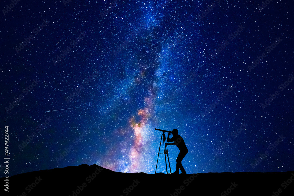 Canvas Prints man looking at the stars through a telescope