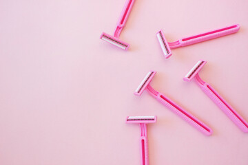 Disposable female razor on a pink background. A tool to remove hair from the skin. Female...