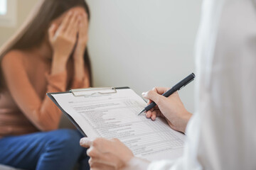 Psychology, depression. Sad, suffering asian young woman consulting with psychologist, psychiatrist...