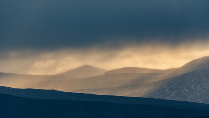 Fototapeta premium Epic Winter landscape image of view along Rannoch Moor during heavy rainfall giving misty look to the scene