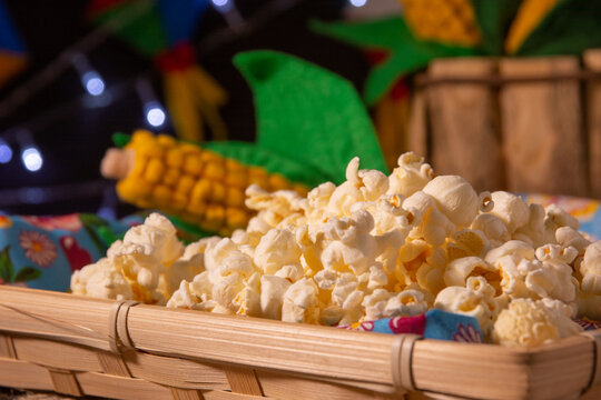 Delicious popcorn in a wooden box, with party decoration. Selective focus.