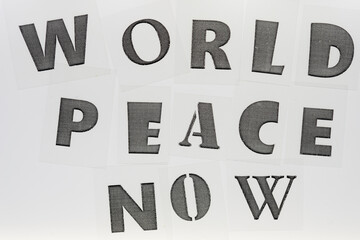 transparency with laser printed letters forming the words "world peace now" on a white background