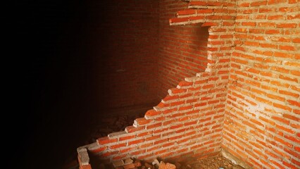 Close-up of the rubble of an industrial building collapsing into a pile of concrete and brick. and...