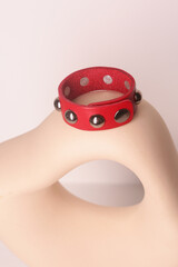 leather studded red bracelet closeup photo on white wall background