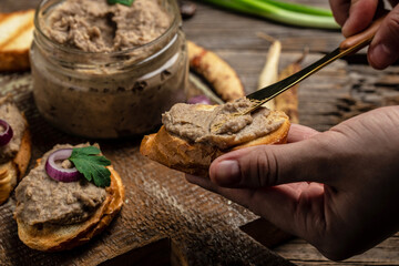 Woman hands spread bread with beans paste, Mexican cuisine pate of beans in glass jar. healthy vegetarian food, top view