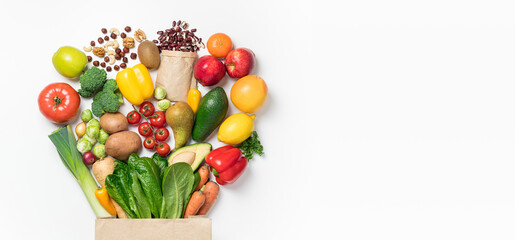 Healthy food background. Healthy food in paper bag vegetables and fruits on white. Shopping food supermarket concept. Food delivery, groceries, vegan, vegetarian eating. Top view - obrazy, fototapety, plakaty