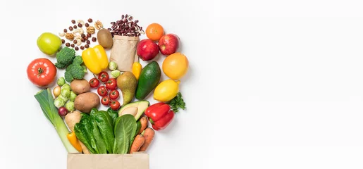 Rolgordijnen Healthy food background. Healthy food in paper bag vegetables and fruits on white. Shopping food supermarket concept. Food delivery, groceries, vegan, vegetarian eating. Top view © missmimimina