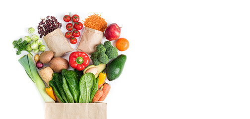 Healthy food background. Healthy food in paper bag vegetables and fruits on white. Food delivery,...