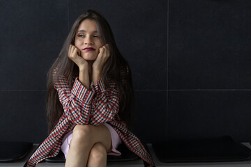 Young Latin American woman (22) sitting in a bored pose. Youth concept