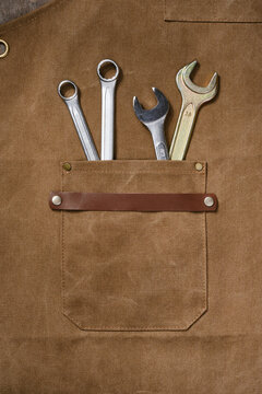 Brown apron pocket with construction tools. Concepts of Labor Day. Selective focus