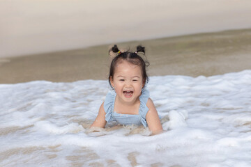 Asian Baby Girl in Bikini Swimming in the Sea for Summer Vacation