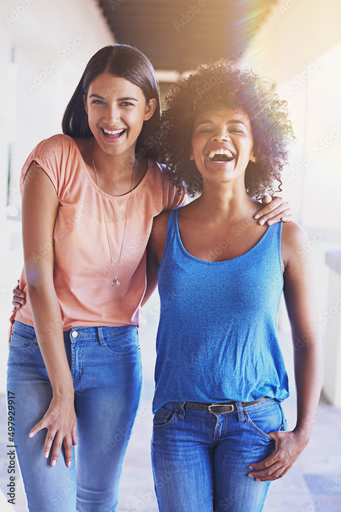 Wall mural Sharing the love, sharing the laughs. Shot of two girlfriends hanging out together.