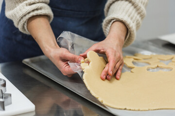 Cook taking cookie mold out of dough