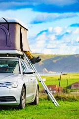 Car with roof top tent camp on sea shore