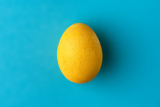 Yellow easter egg on blue background. Colors of the flag of Ukraine. Stop war