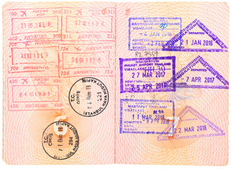 Opened depersonalized Russian passport with stamps on border crossing. Departure and arrival immigration stamps. Passport page with the immigration control. Russia, Turkey and Thailand customs stamps