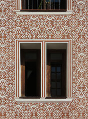 Detail of facade and window with sgraffito geometric decoration in the historic city center of Madrid. Spain. 