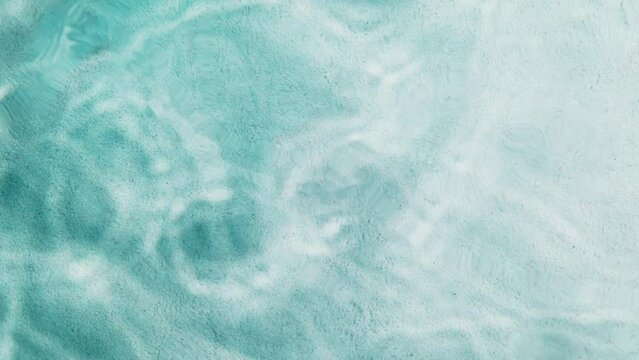 Super Slow Motion Shot of Clear Blue Sea Surface Waving Over White Sand Beach at 1000fps.