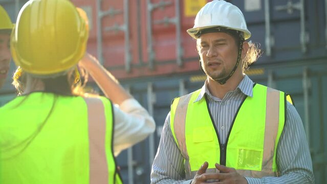 diversity worker foreman and secretary using document file meeting with worker to checking  control loading Containers box at warehouse logistic in Cargo freight ship for import export in harbor.