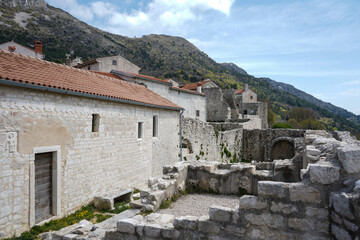 Ancient abandoned medieval town Plomin, Istria Croatia.  Old stone street with ruined walls houses and stairs.