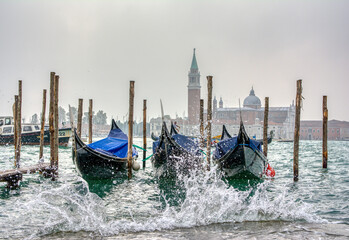 Gondolas parked at San Marco square with high tide.