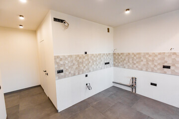 Modern living room design in light white color with glass dark metal square transparent partition with lamps in the ceiling. How to separate creative the workplace from the kitchen or cooking area