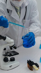 Laboratory scientists work with in vitro liquid test tubes for healthcare researchers, and medical...