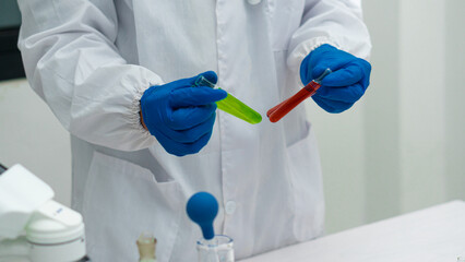 Laboratory scientists work with in vitro liquid test tubes for healthcare researchers, and medical...