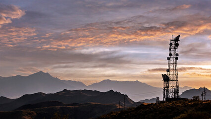 Landscape with cell phone communication tower with sunset and rocky desert mountains near Phoenix...