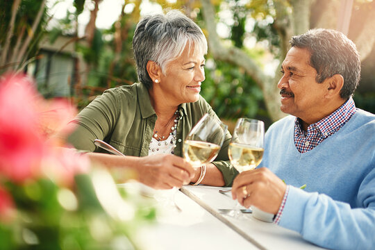 Every Second With You Is A Reason To Celebrate. Shot Of A Happy Older Couple Sharing A Toast Over Lunch Outdoors.