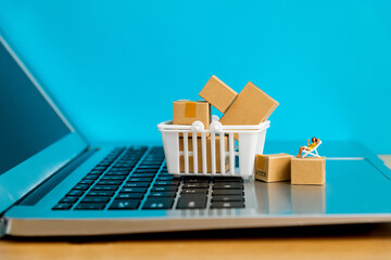 Female figurine and boxes on laptop keyboard