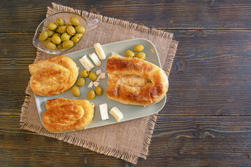 Balkan cuisine. Bureks ( filled pastry, popular national dish ), olives and local white cheese on...