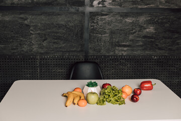 Vegetables and fruits are on a white table