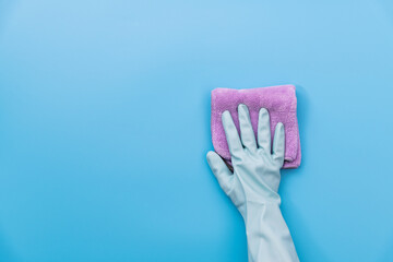 Hand clean with rag on blue background