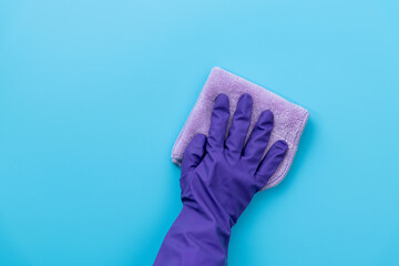 Hand clean with rag on blue background