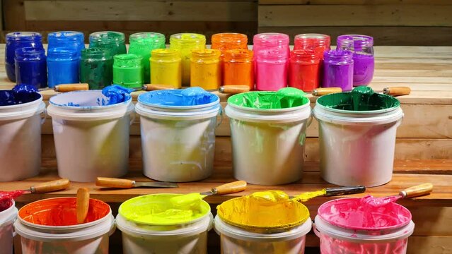 colorful of Plastisol Ink in tee shirt factory..colorful Plastisol ink on pine wood table. .Plastisol ink useful in tee shirt factory and in industry for export.
